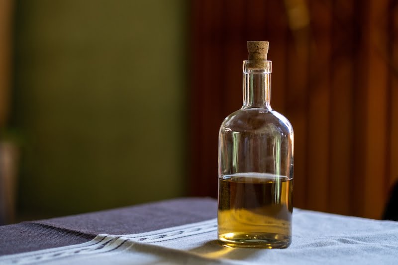 A selective focus shot of a bottle of Tequila on a table with a burred background
